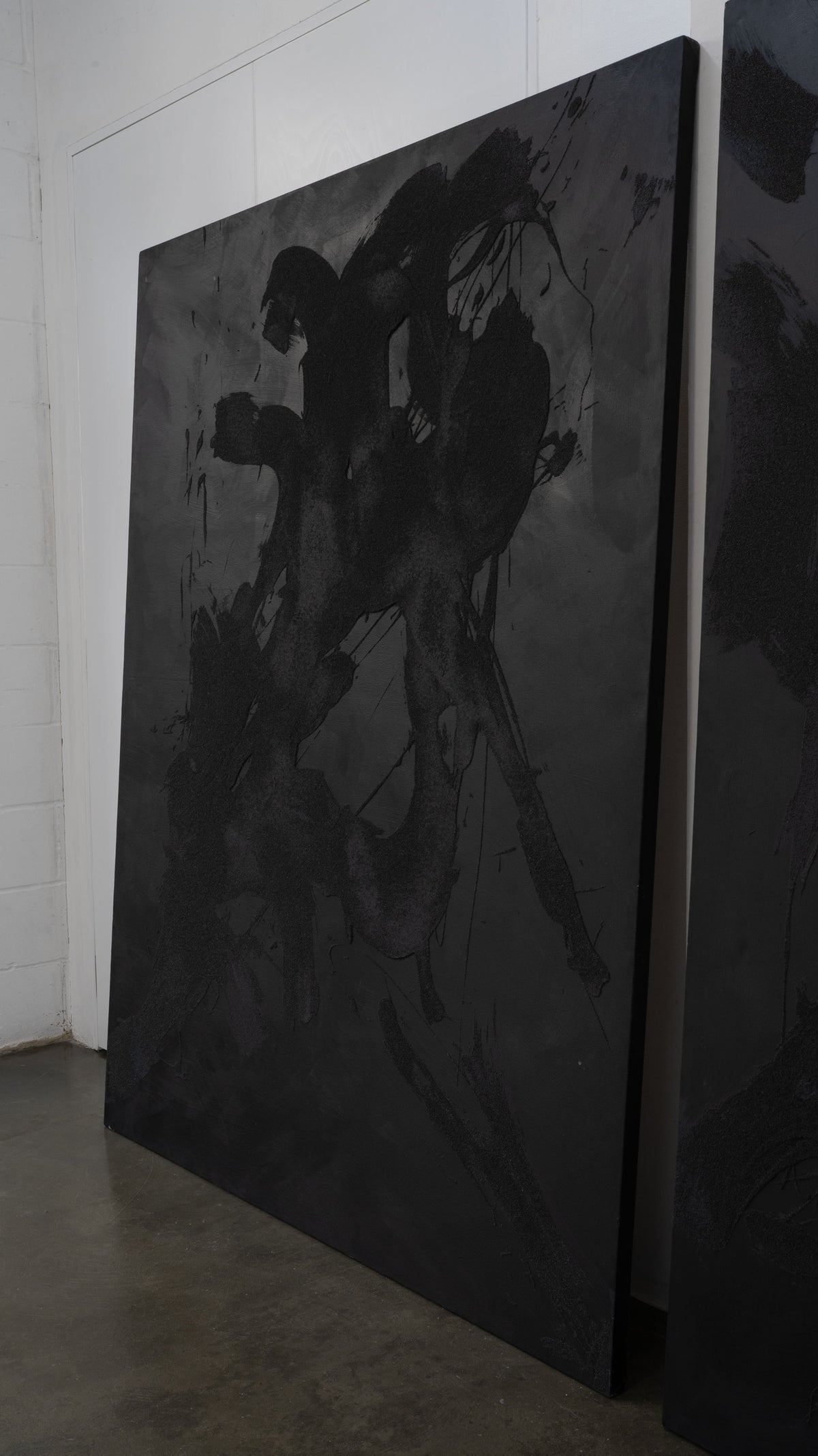 Monochromatic abstract canvas with bold black brushstrokes detail