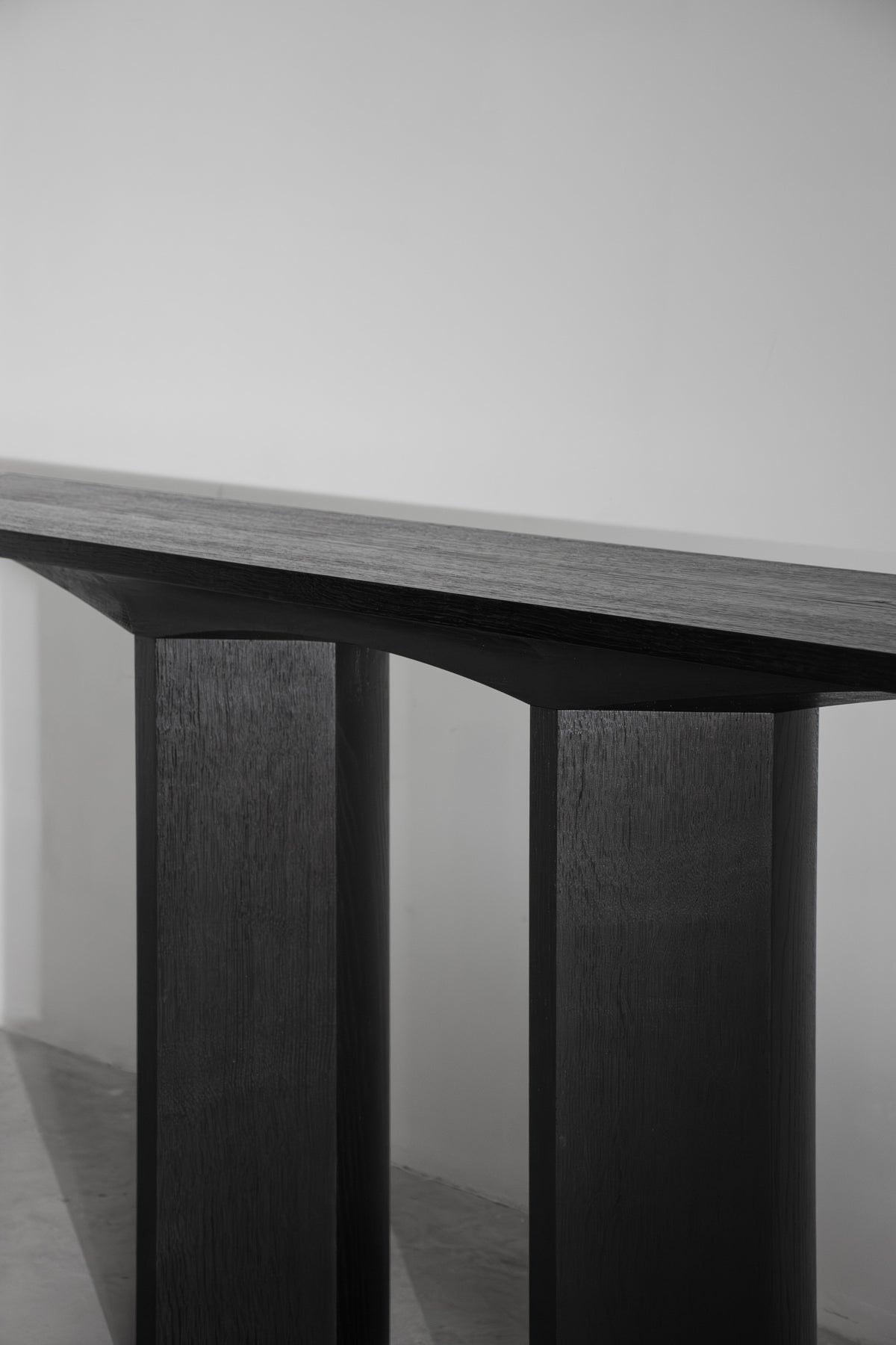 Corps - Console — close-up of dark wooden tabletop and legs