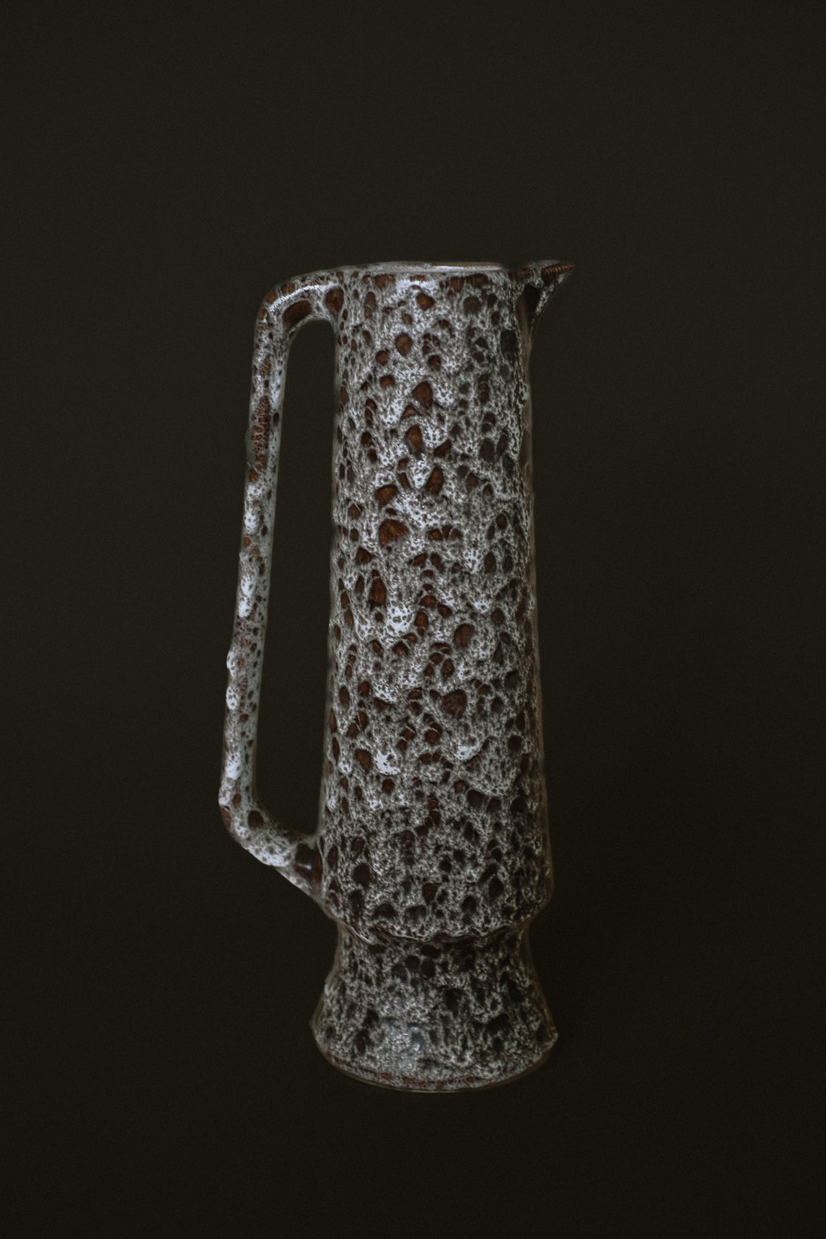 Textured stoneware pitcher with organic bubble pattern detail