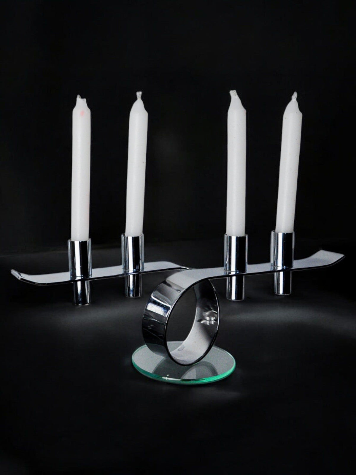 Space-age 4-flame candlestick, glass and metal, Germany, 1980 — close-up of chrome base with white candles
