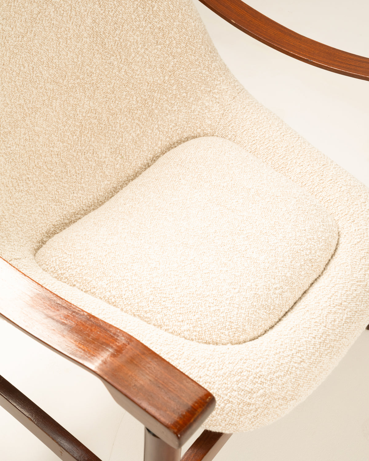 Close-up of cream fabric seat cushion on Tiki armchair frame