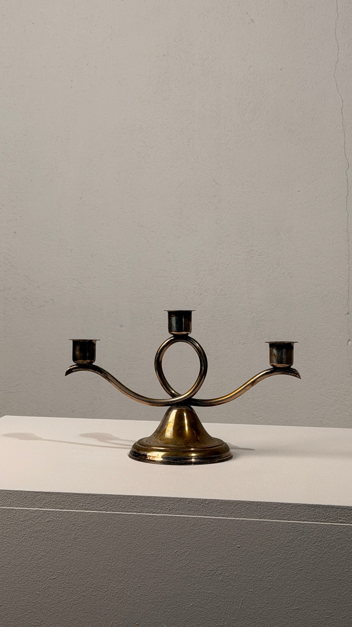 Silvered Metal Candelabra, France, 20th Century — side angle on white surface
