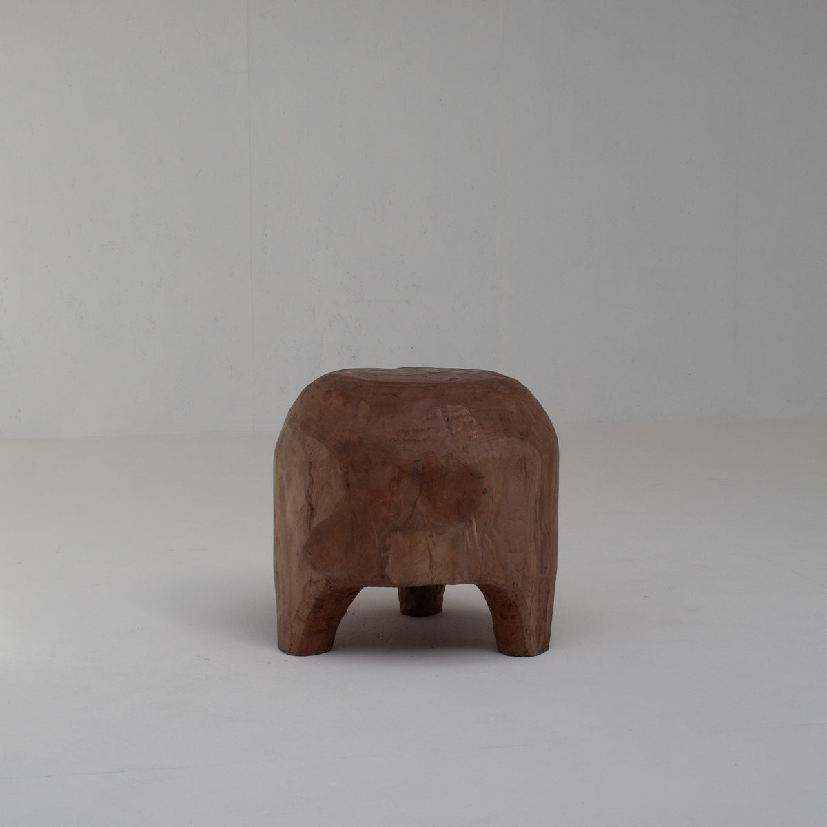 Sculptural Solid Wood Stool in Warm Natural Patina — detail view