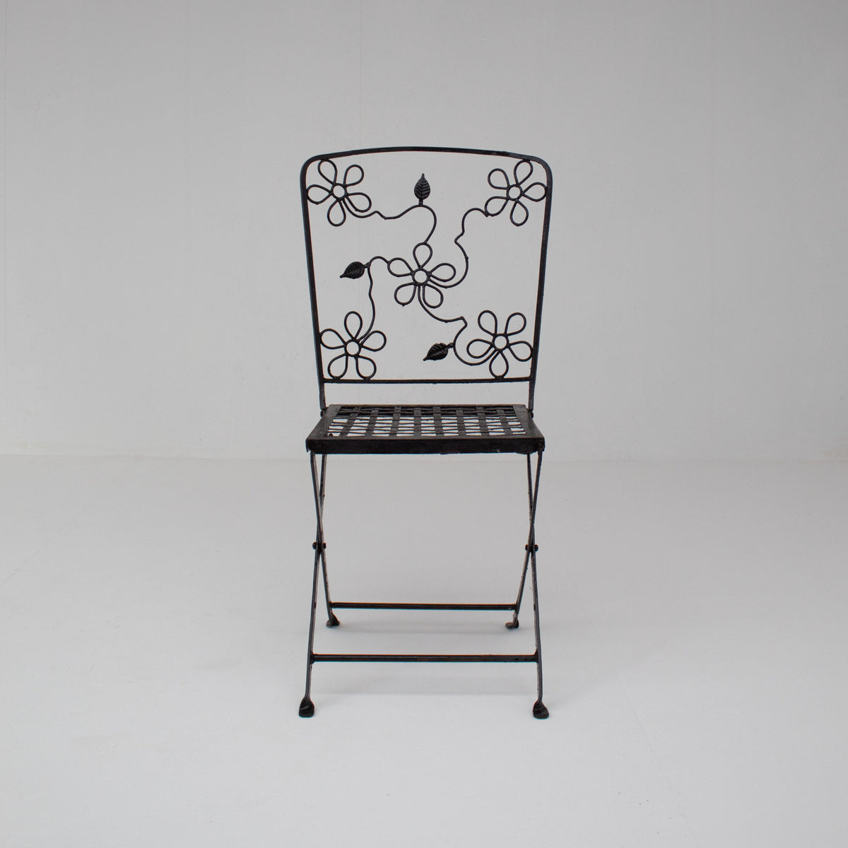Set of Three Decorative Wrought Iron Garden Chairs with Floral Backrests — in context