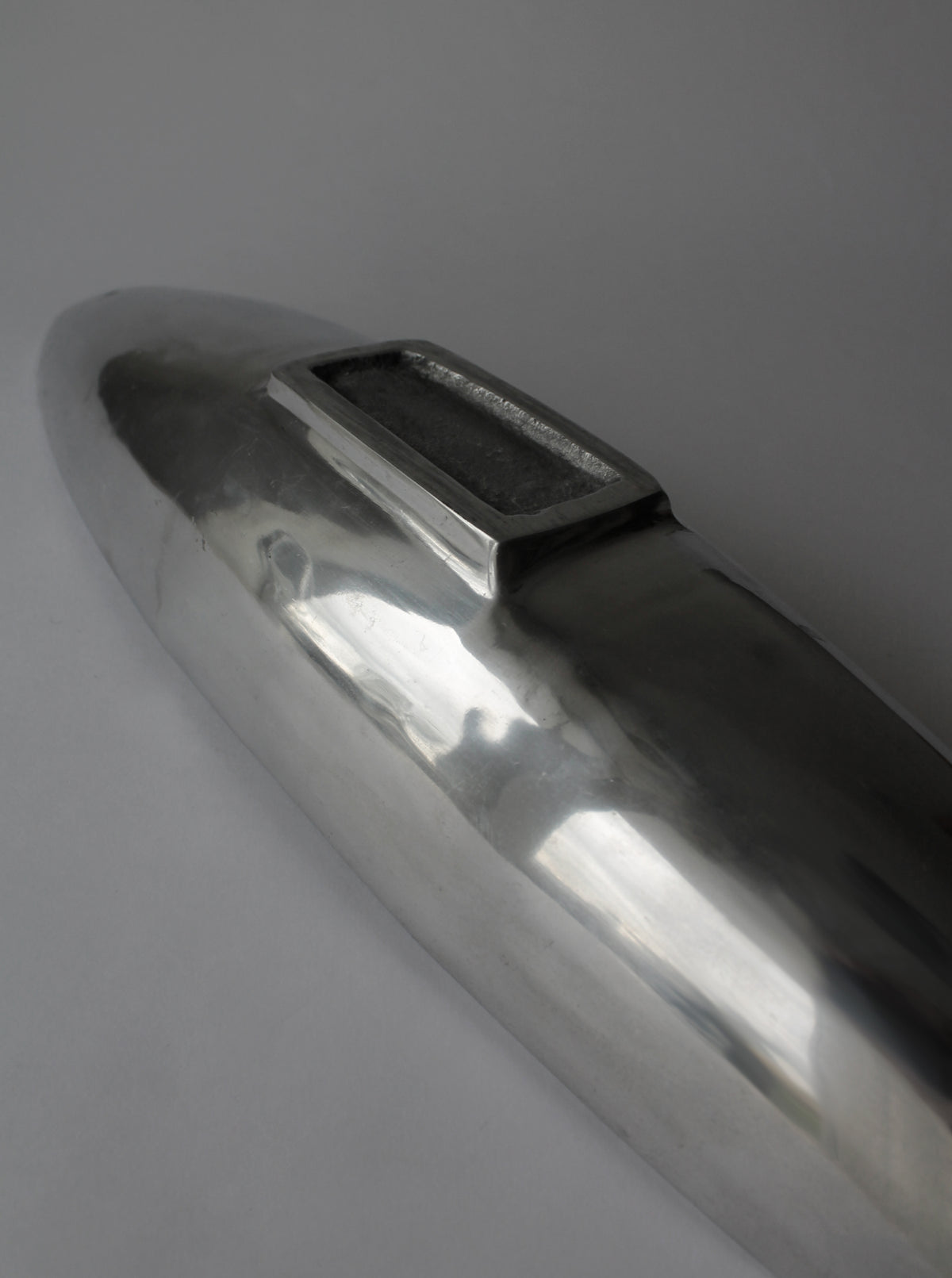 Polished aluminum bowl detail showing sleek modern finish and handles