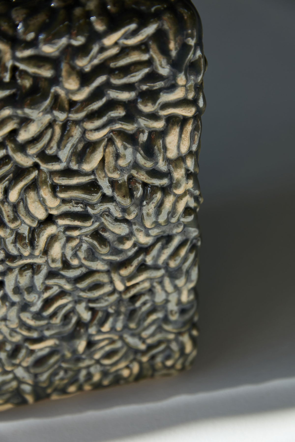 Close-up detail of iridescent ceramic texture on Molecules vase