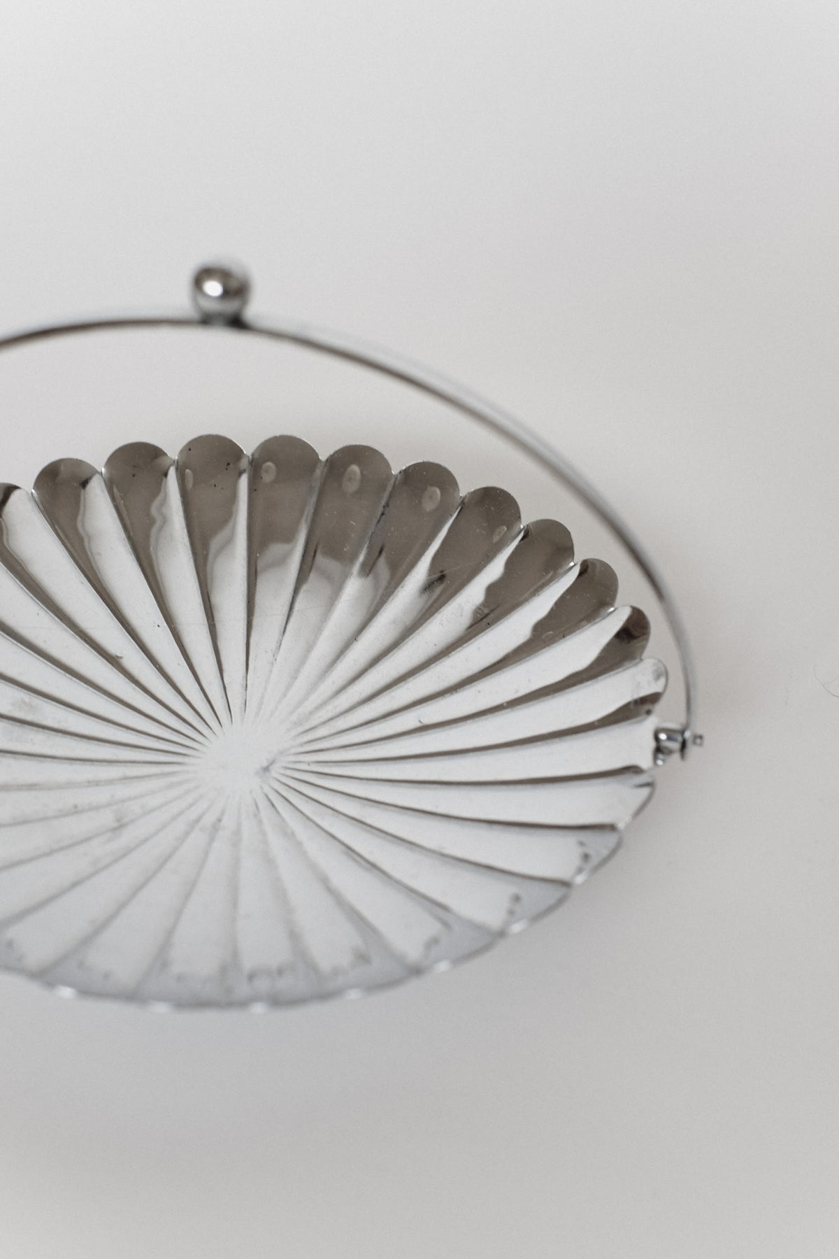 Serving Dish With Handle — side angle of polished metal surface