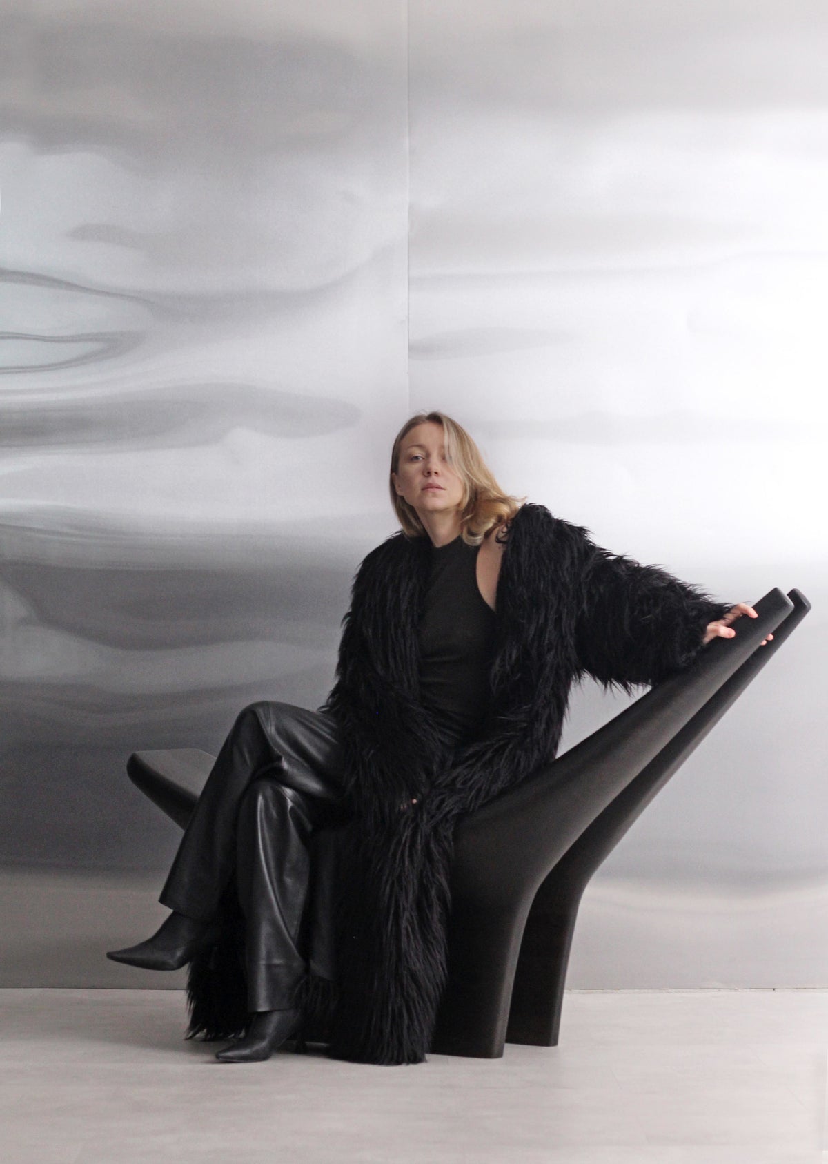 Dym Lounge Chair — side angle with black finish in modern setting