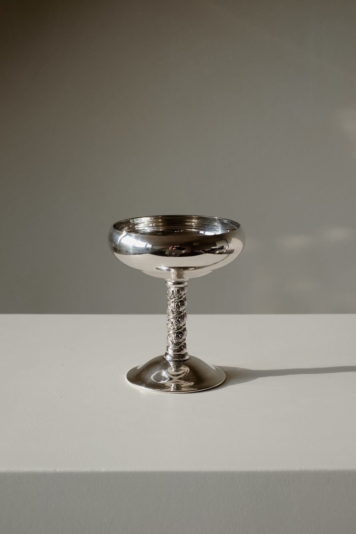 Set of 6 Silver Coupes — close-up of polished silver cup on white surface