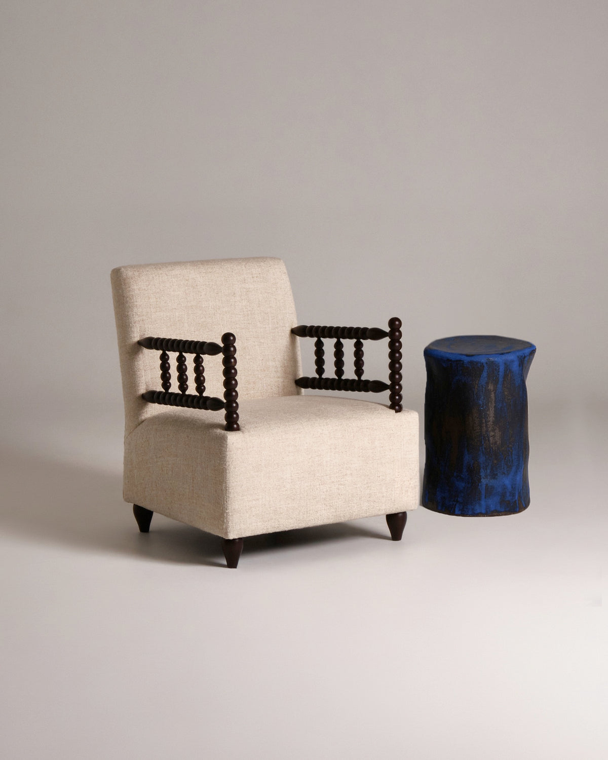 Bolha Lounge Chair — back view with beige upholstery and wooden arms