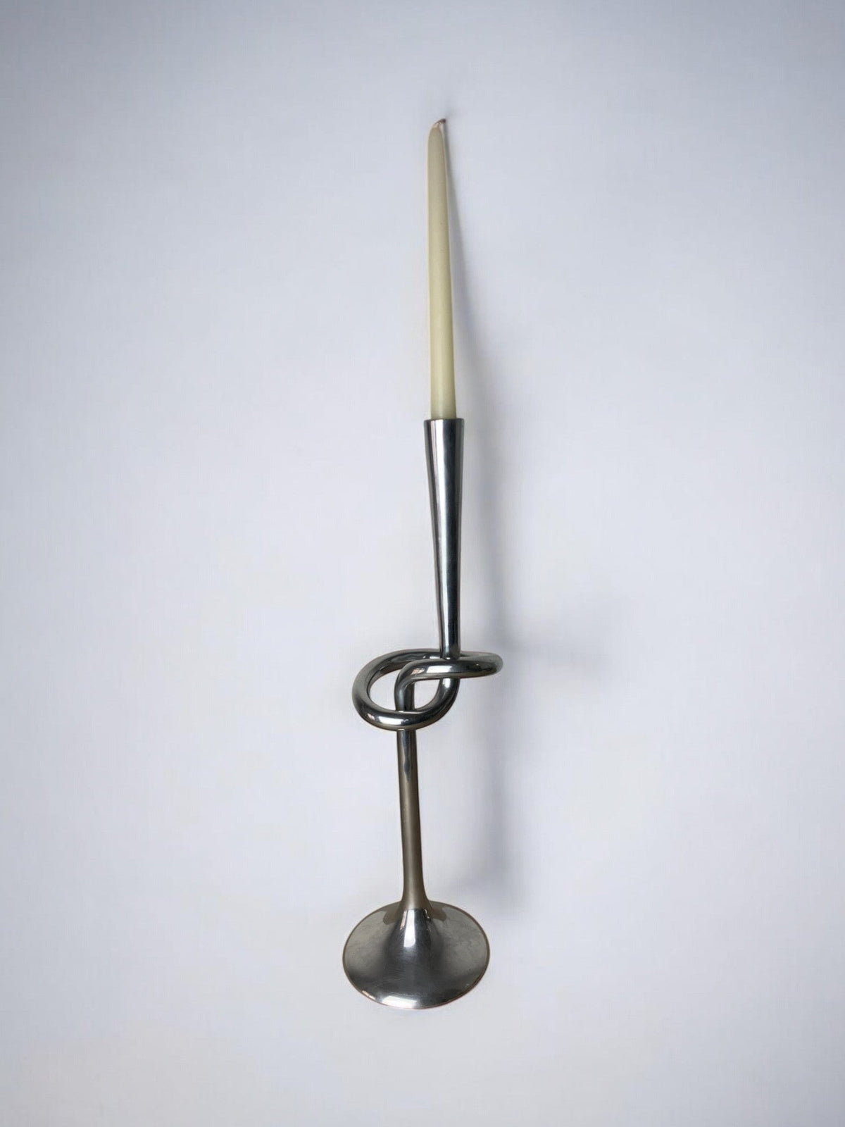 XL knotted candlestick in Solid aluminum, Italy, 1980 — lifestyle setting