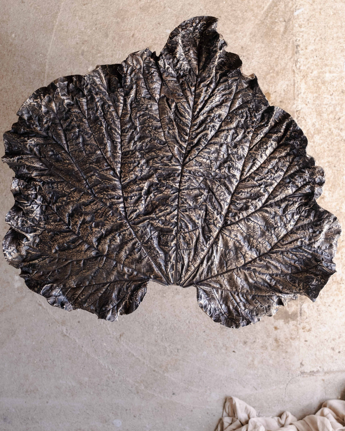 Bronze rhubarb leaf side table detail showing textured surface
