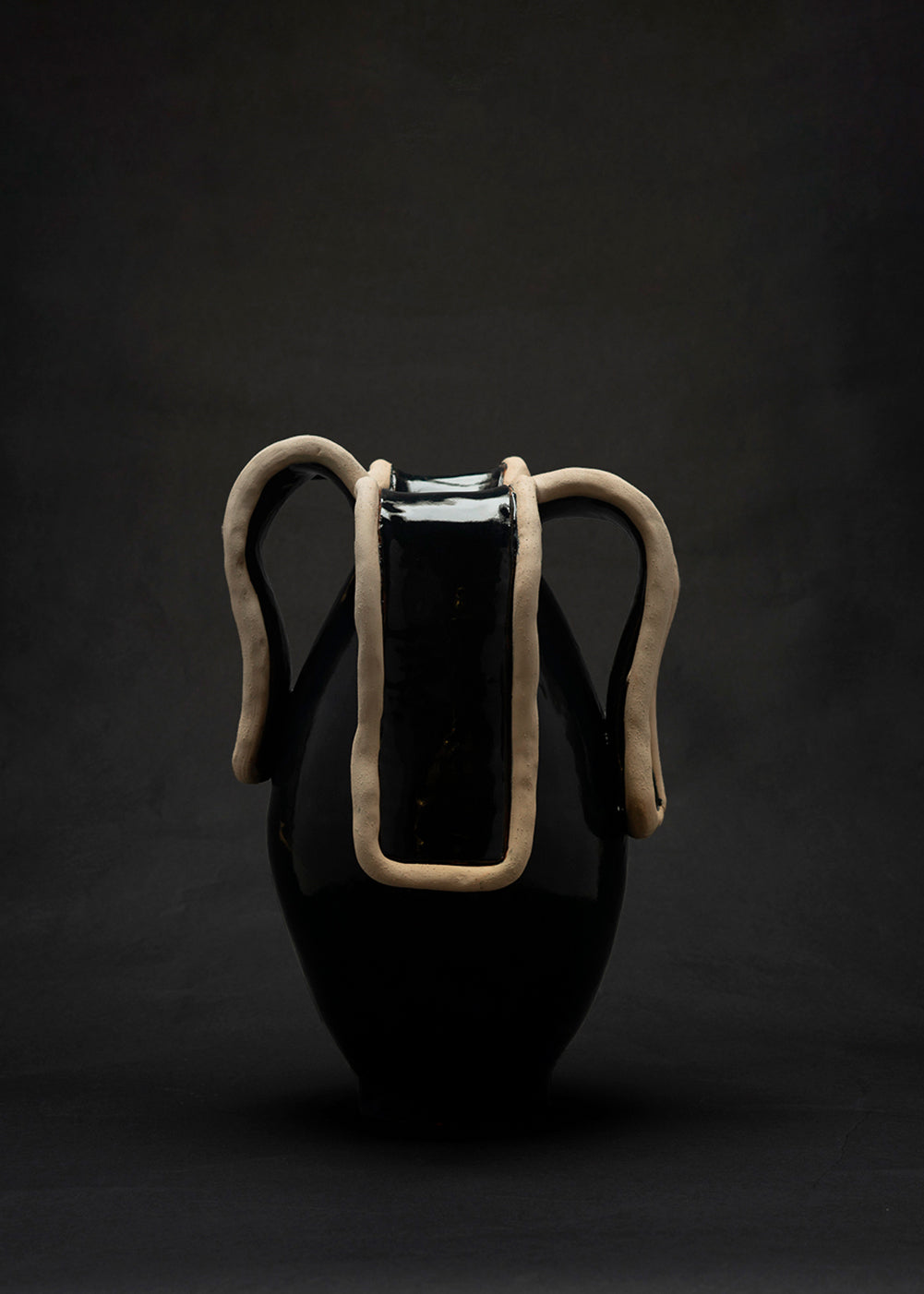 Navy blue ceramic vase with unglazed sculptural handles detail