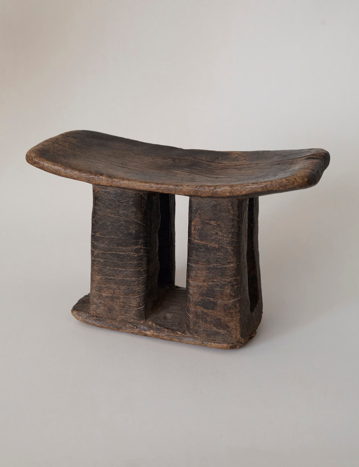 West African Monoxyle Stool in Dark Patinated Wood — lifestyle setting