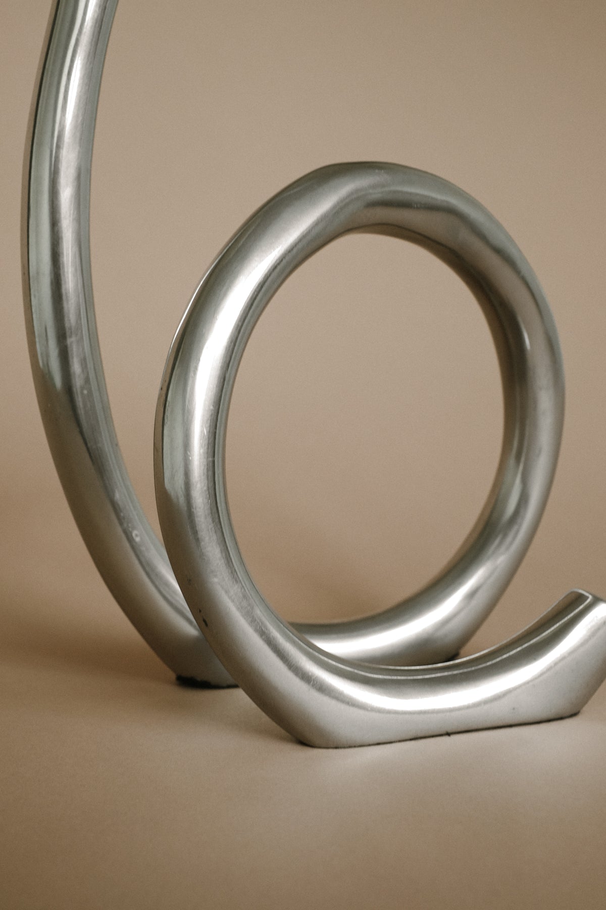 Curved silver metallic vintage candleholder sculptural detail view