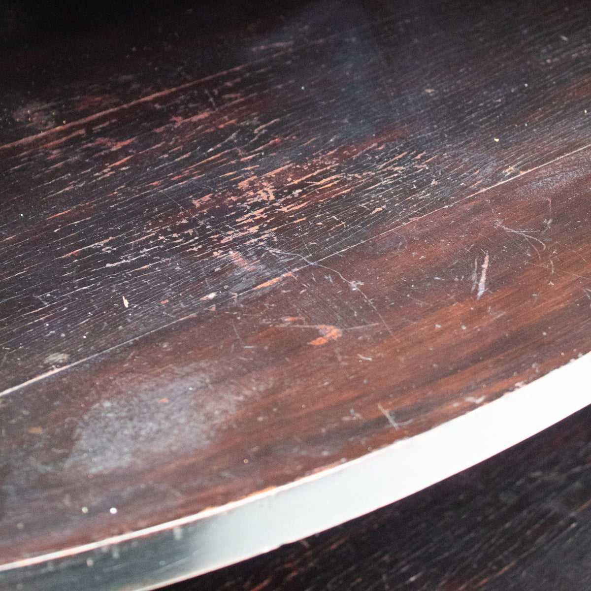 Art Deco Cabinets — close-up of dark wood surface with metal edge