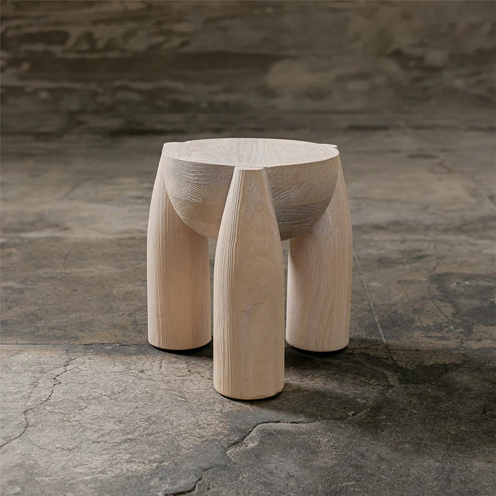 ELEMENTOS Set of Stools, sandblasted pine with black finish — side view on textured stone surface