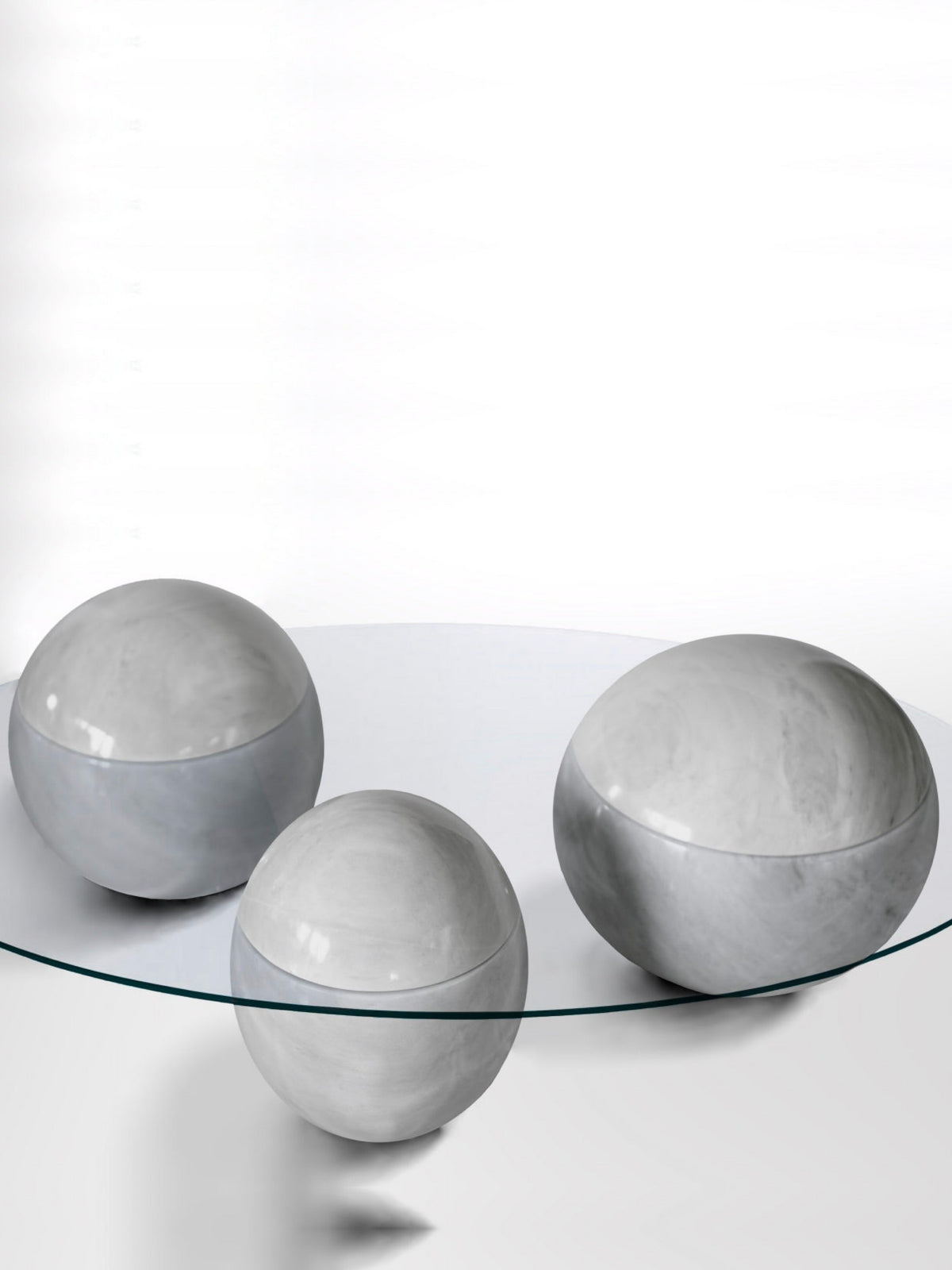 Ovni Uovo' Coffee Table — three gray marble spheres under glass top