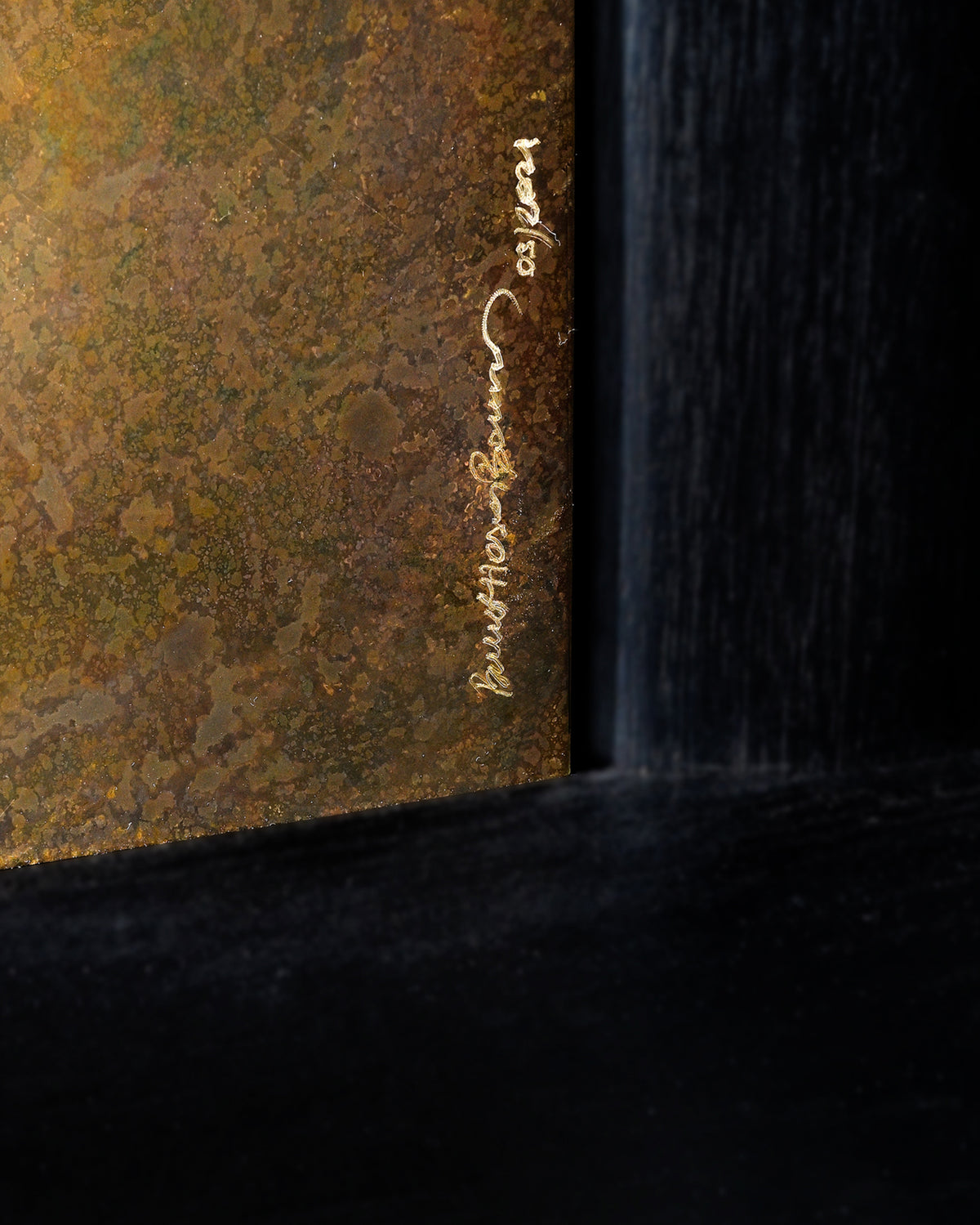 Close-up detail of Era credenza signature engraved on corner