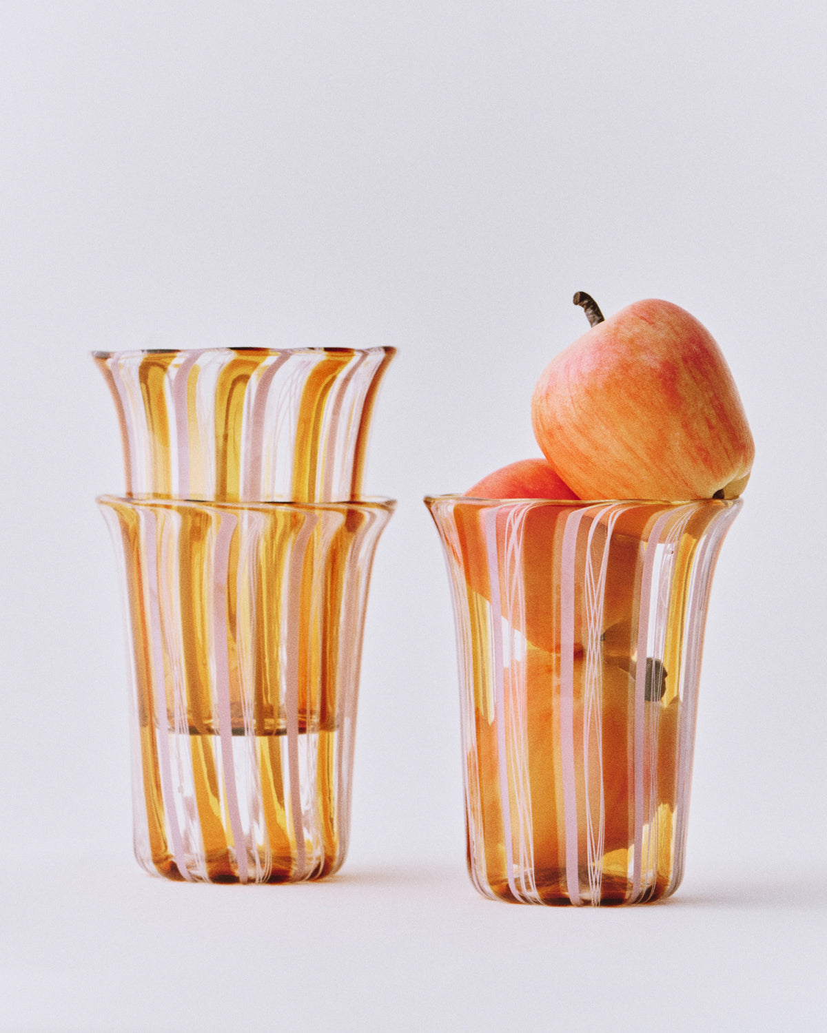 Clara Glasses - Set of four — side view with amber glass and apples