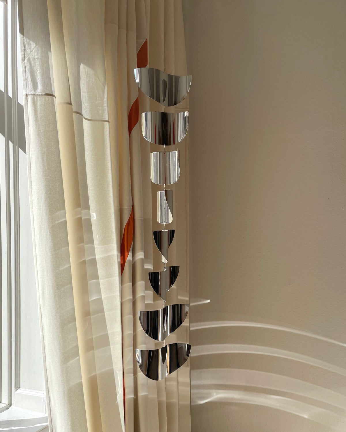 Modern spiral sun catcher sculpture with reflective chrome discs