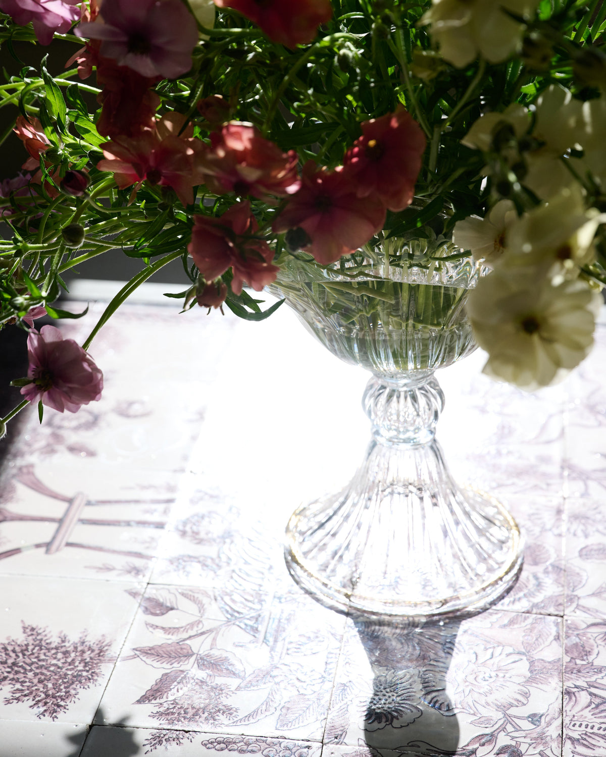 Blixen Vase Large — back view with clear glass and floral arrangement
