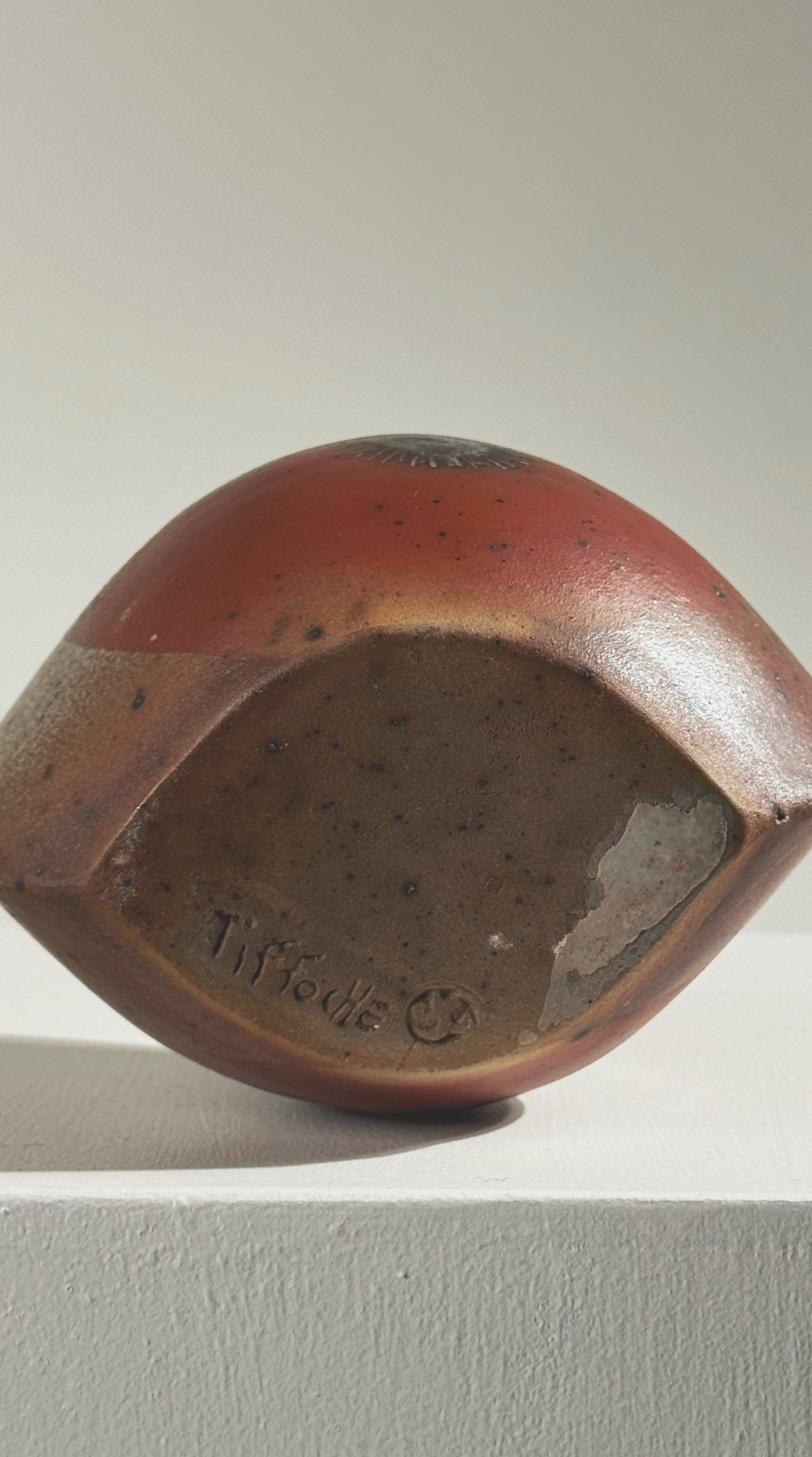 Bottom view showing Gustave Tiffoche signature on stoneware vase