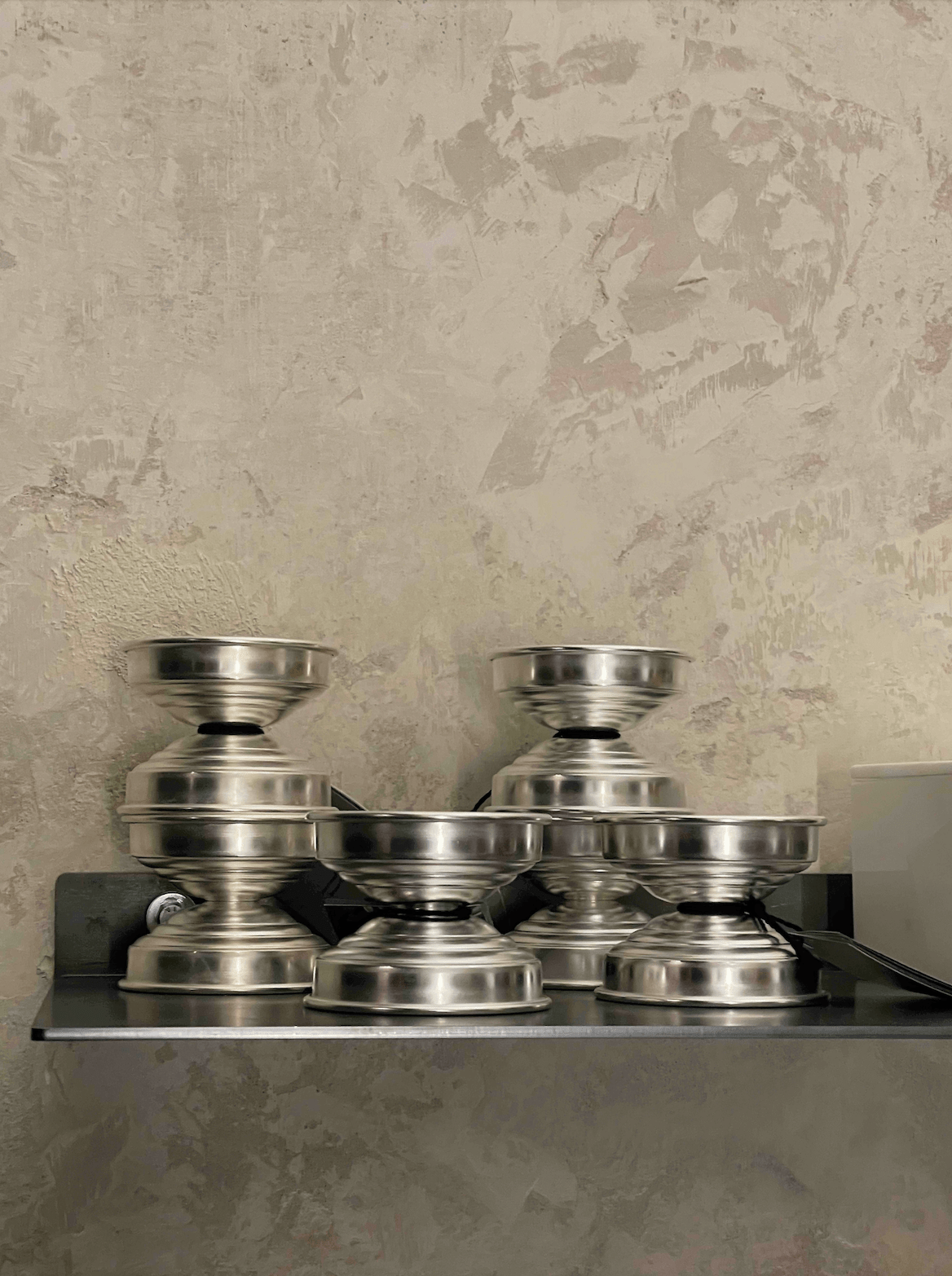 Metal Candle Holders in Polished Aluminum — side view stacked on shelf