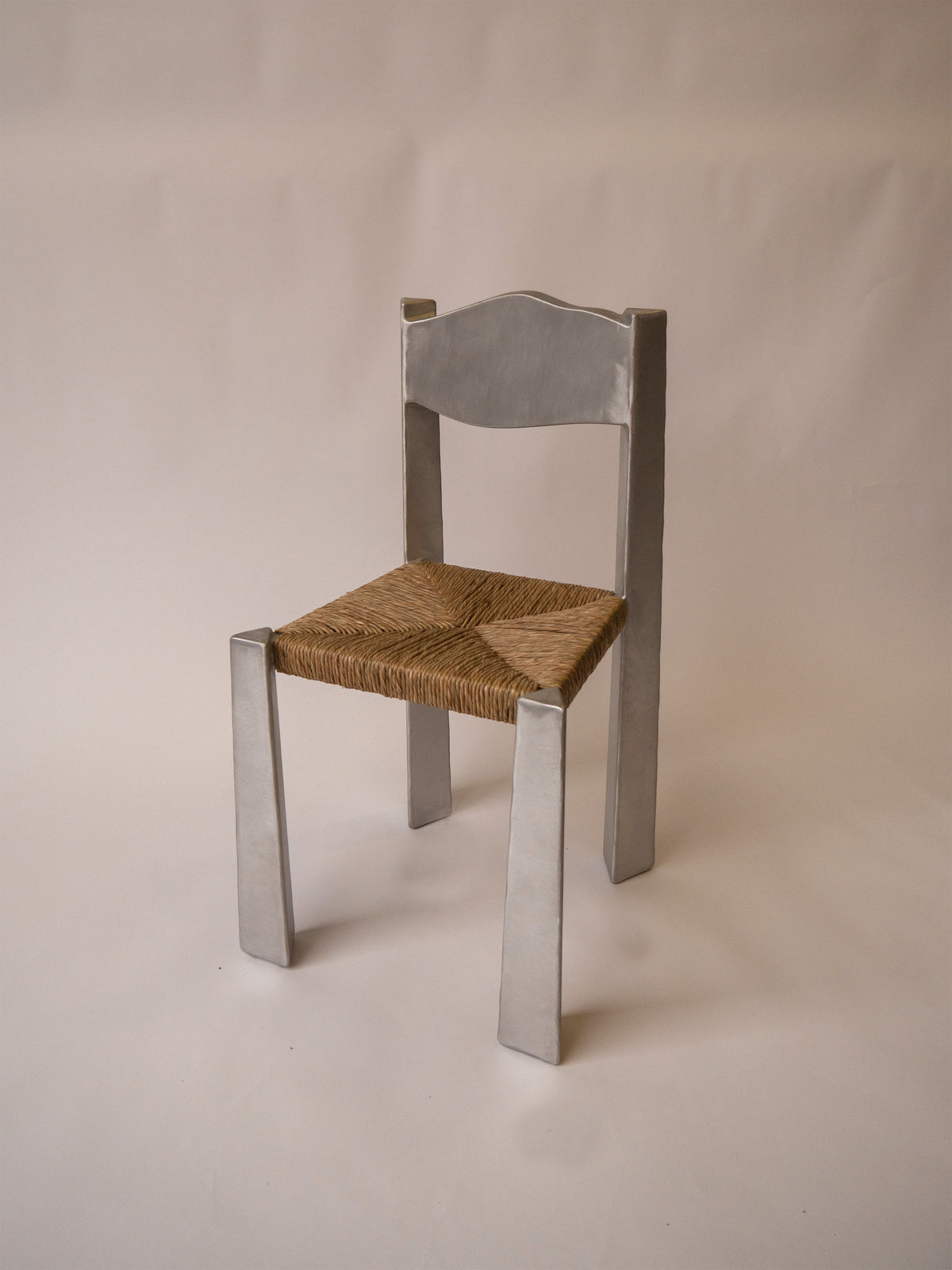 Woven Chair — side angle highlighting woven seat and metallic legs