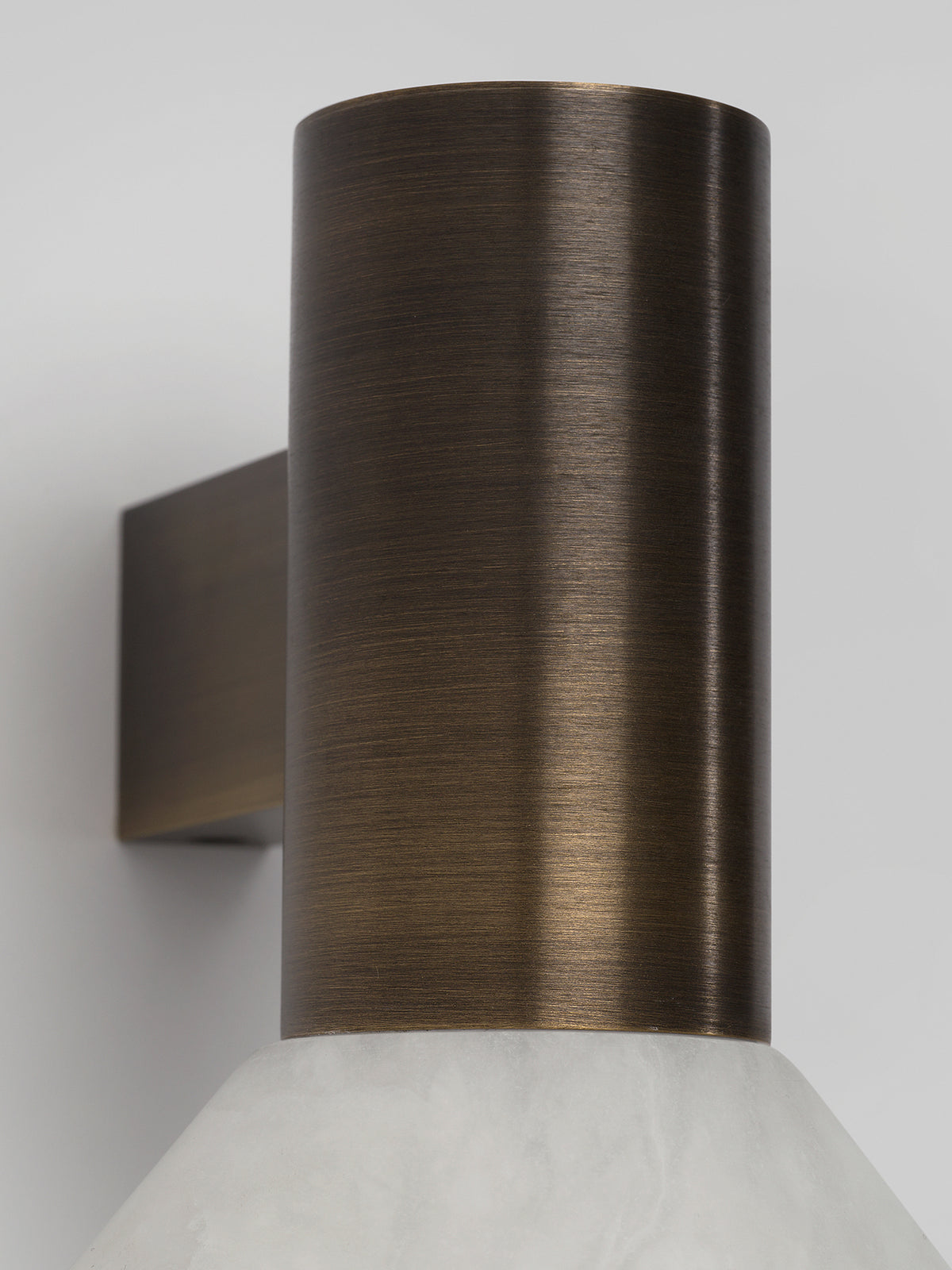 TORRES Wall — close-up of brushed bronze finish and marble base