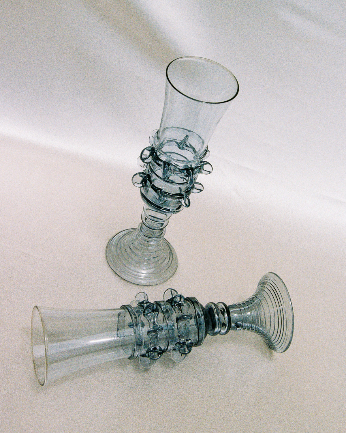 Pair of handblown glass champagne flutes with seaweed spiral stems