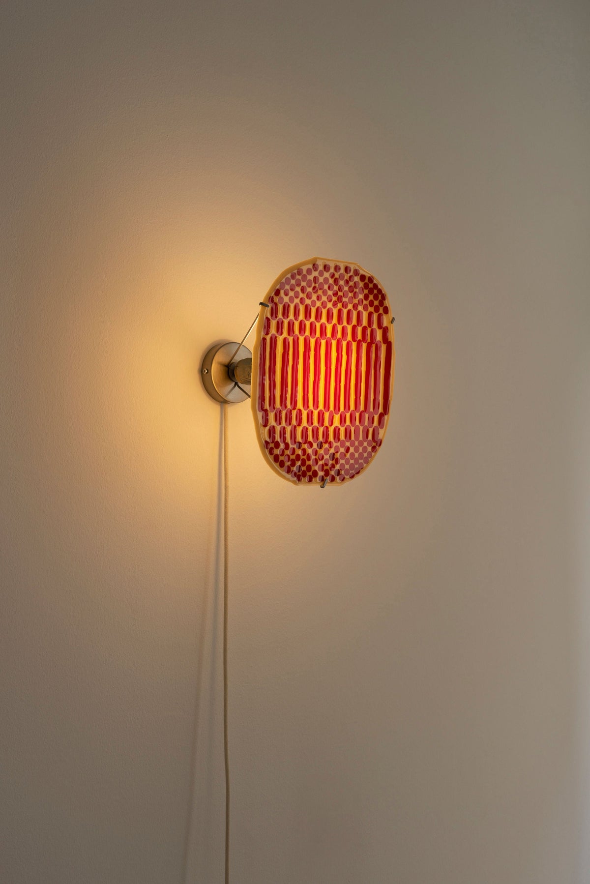 Beige Checker Wall Lamp illuminated, red woven glass detail