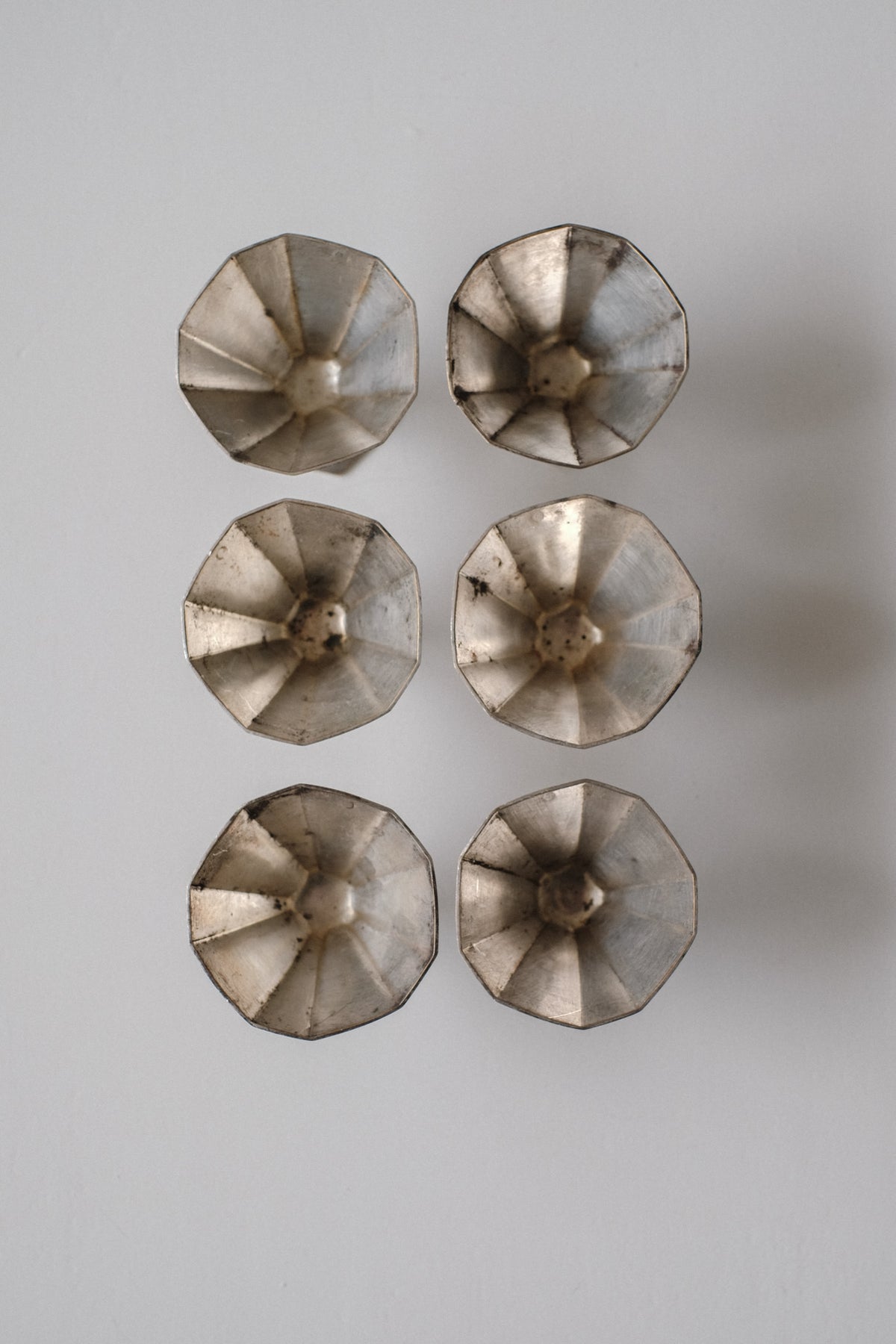 Art Deco Small Cups — overhead view of metallic cups arranged in grid