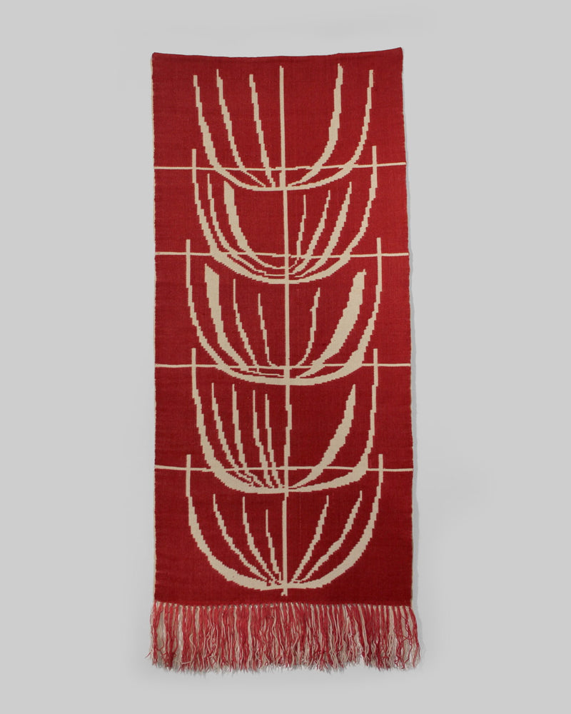 The Red Wool Wall Tapestry With Abstract Nature Motifs by Vintage Stories (72x180cm) features red, cream, and light gray geometric designs with overlapping shapes, thin cream dividing lines, and a long fringed edge.