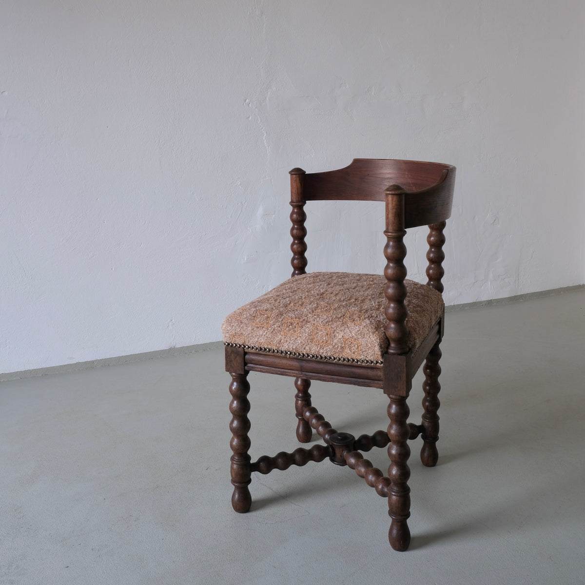 Antique corner chair with bobbin turned legs and upholstered seat