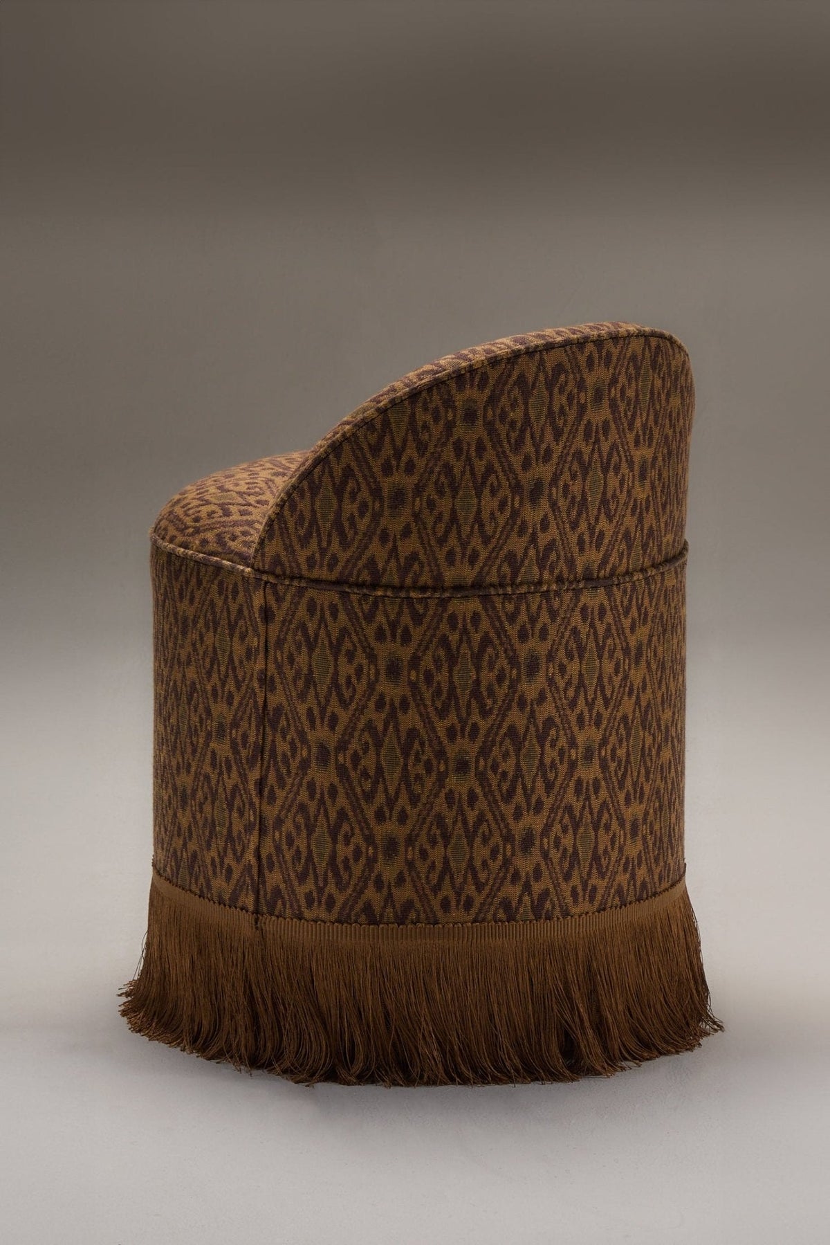 INFERI STOOL - WOVEN IKAT — side profile with woven fabric and fringe