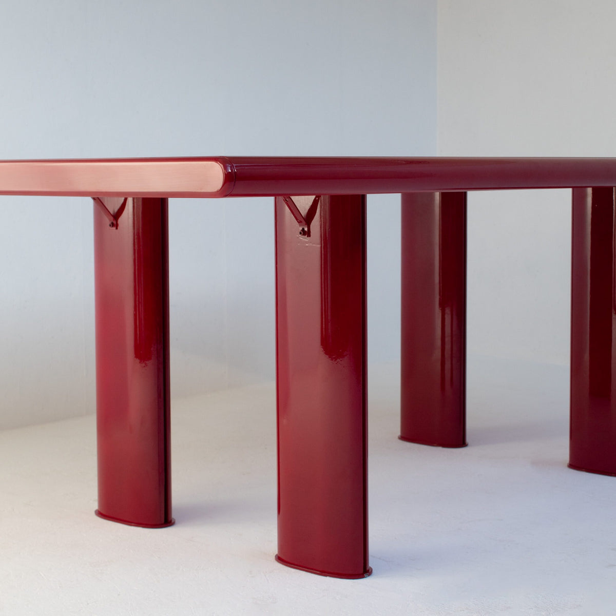 Red Lacquered Dining Table in Wood and Metal — back view highlighting red metal legs