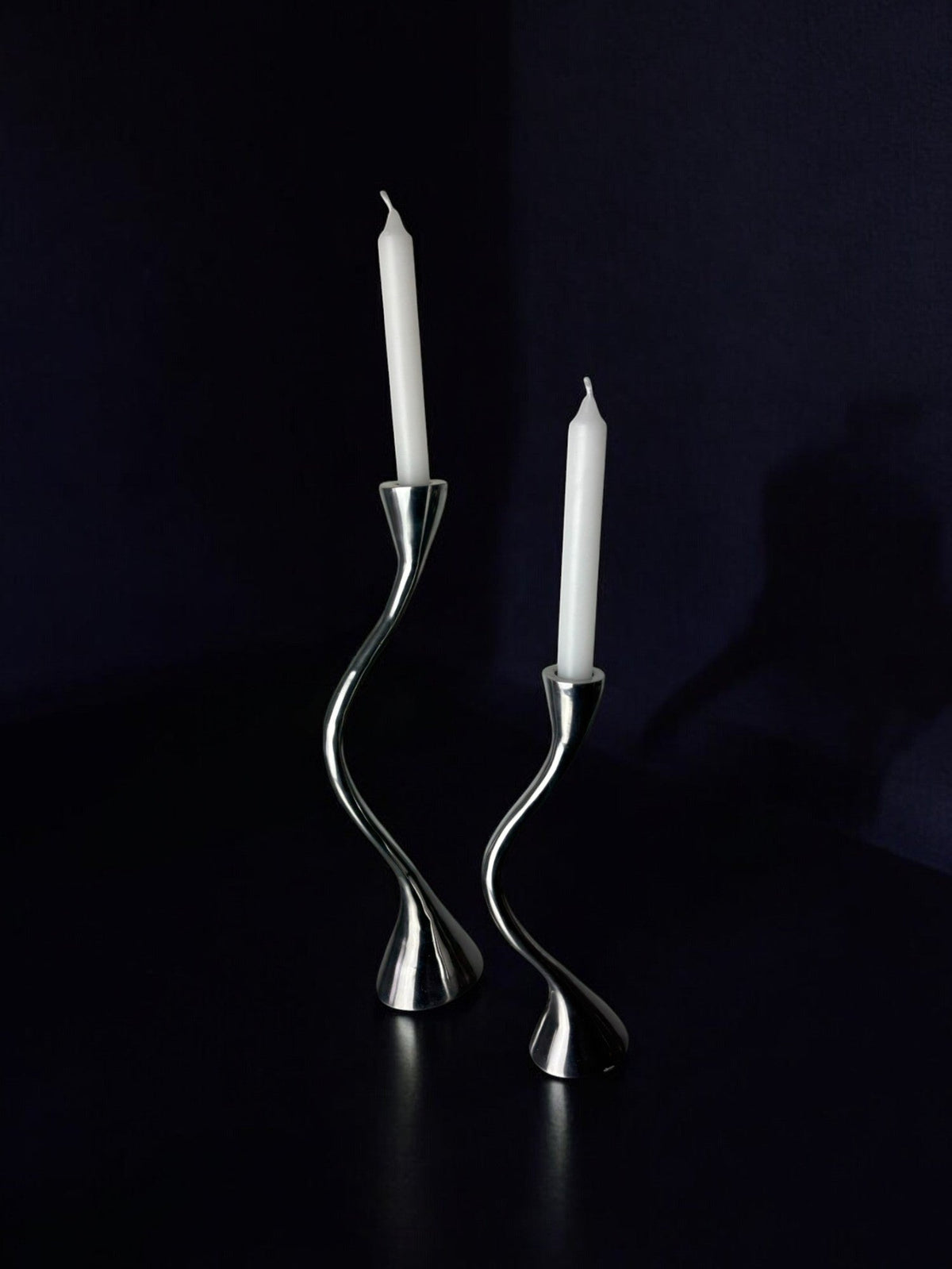 Pair of Zigzag Candleholders, Solid Aluminium, Spain, 1980s — side angle on dark surface