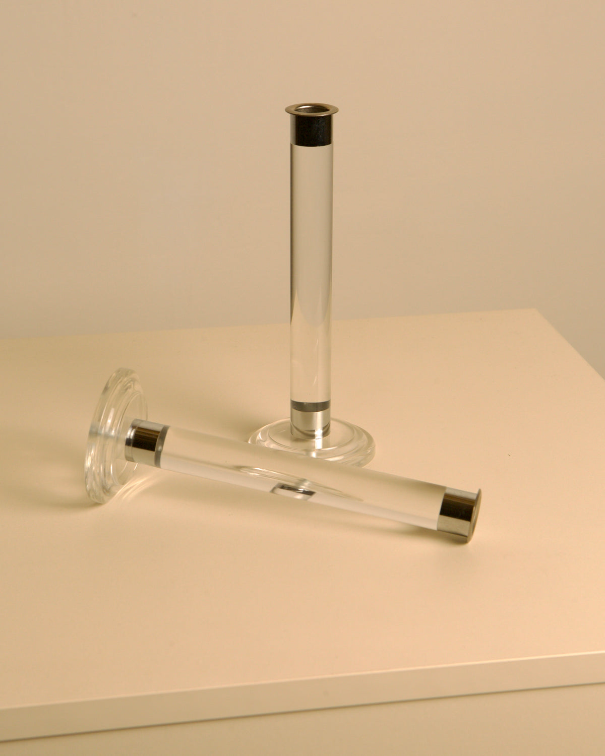 Italian lucite candleholders with silver accents lying horizontally