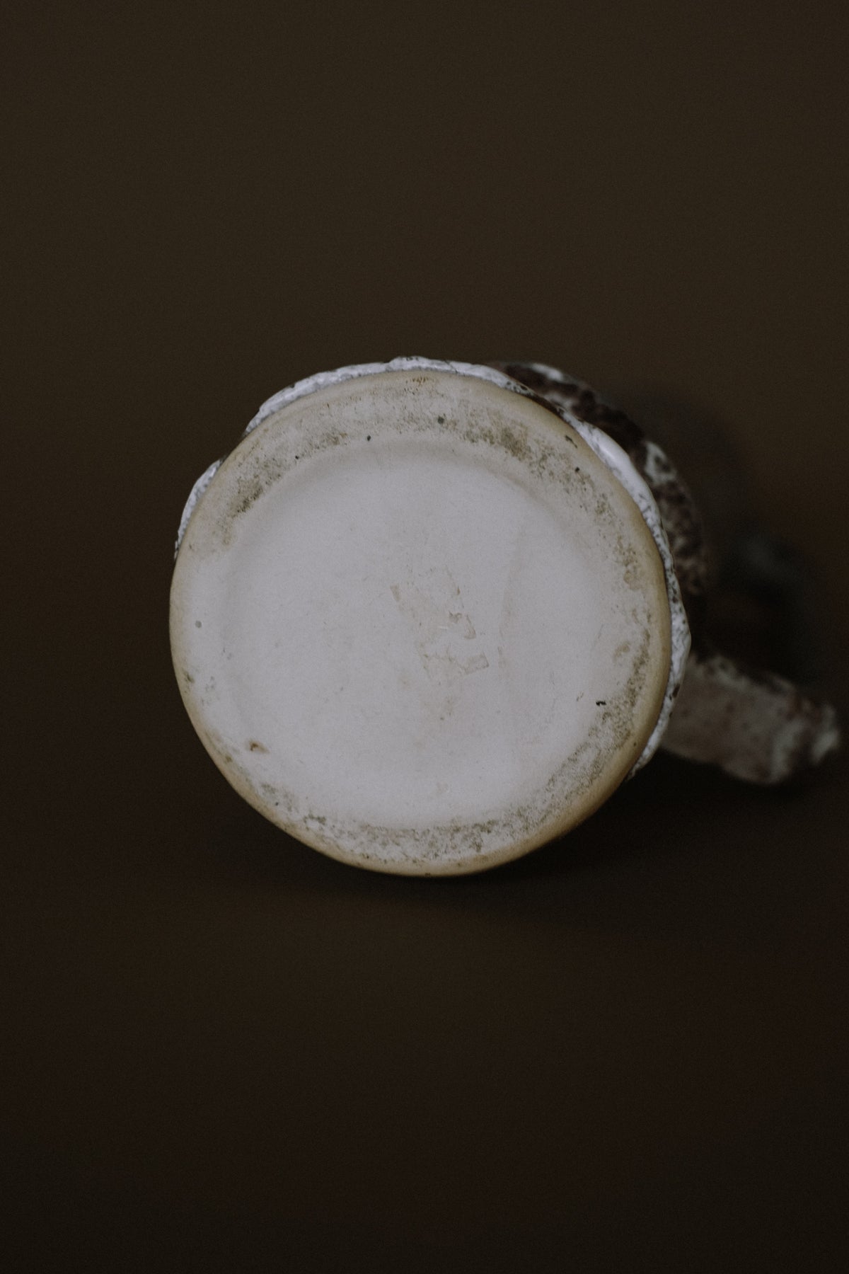 Bottom view of handmade stoneware pitcher showing glazed interior