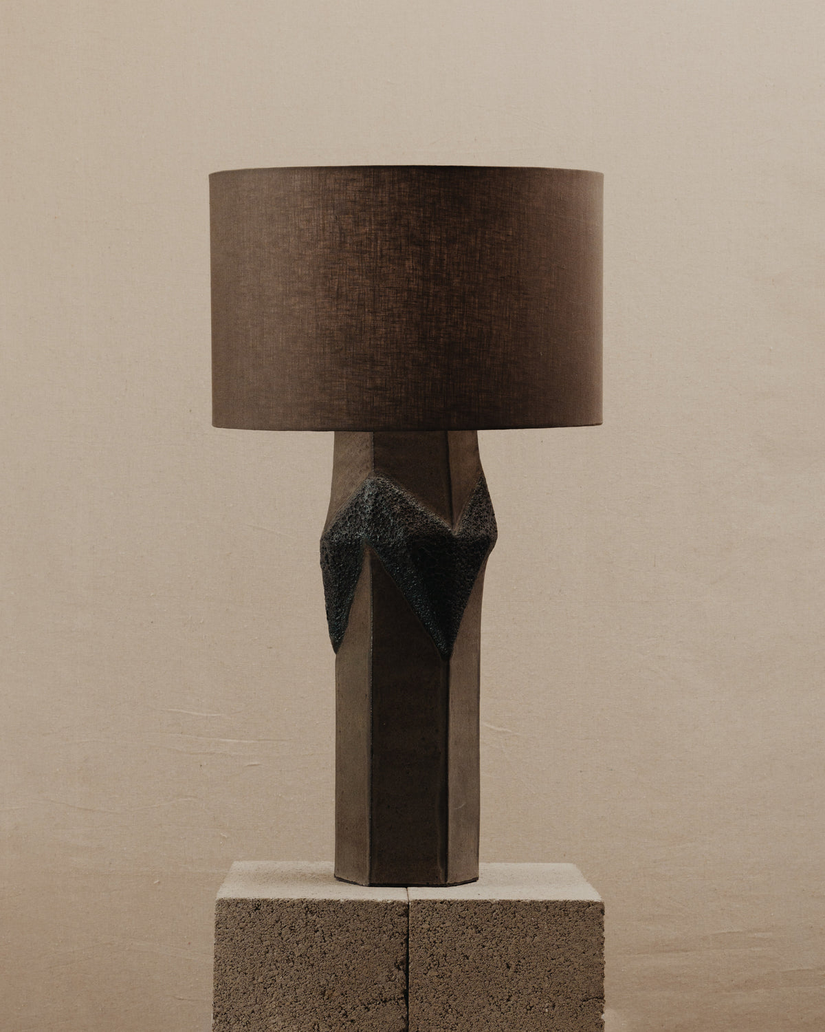 Warp Lamp — close-up of textured concrete base with brown shade