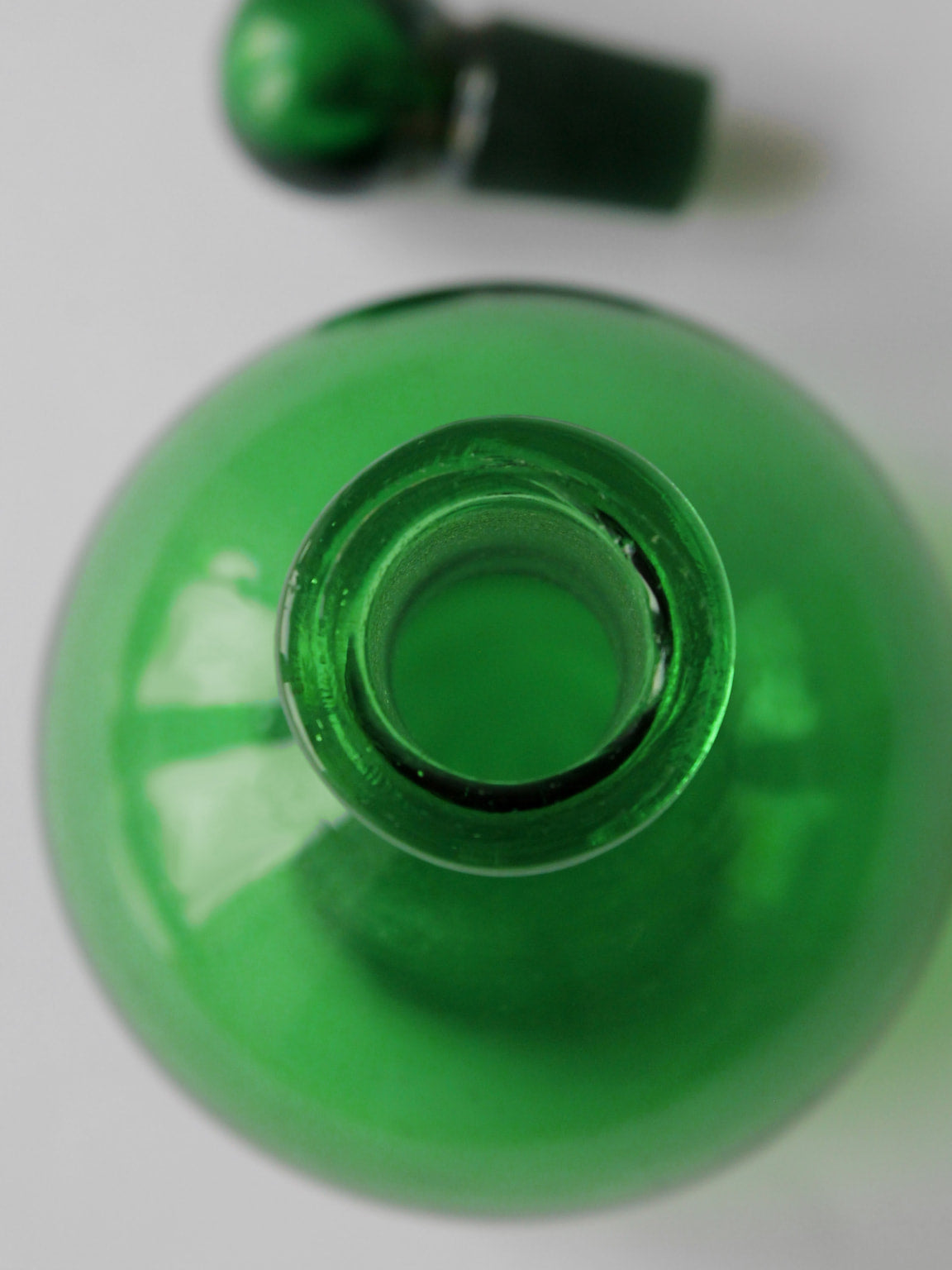 Top view emerald green vintage glass perfume bottle opening