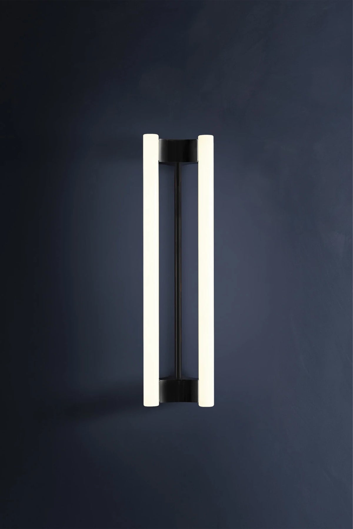 LIA WALL SCONCE 50 — modern black and white wall light on dark wall
