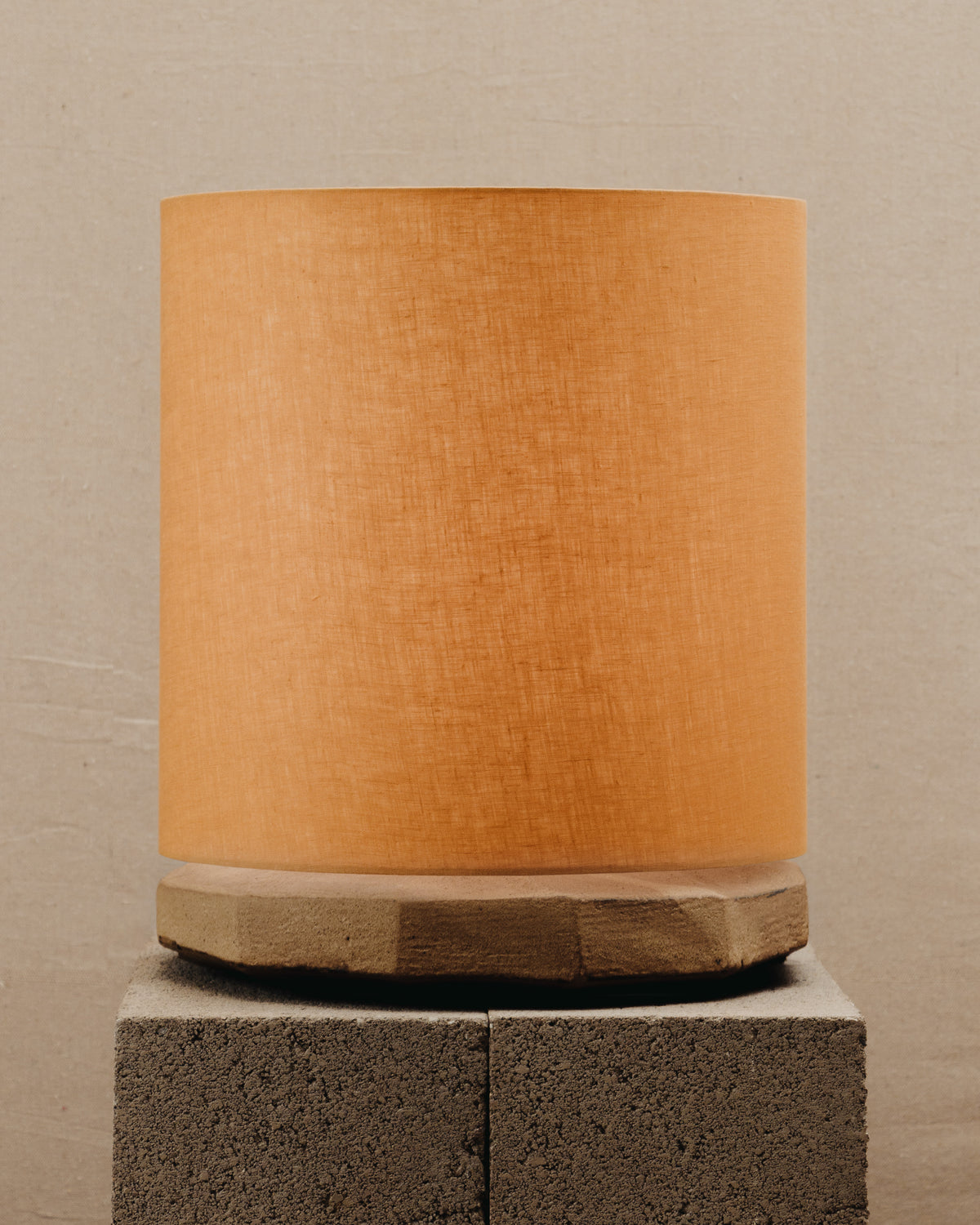 Radian Lamp — top view of orange fabric shade on stone base