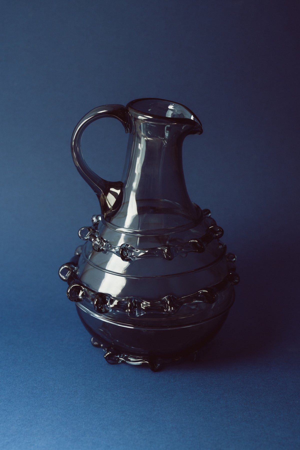 Contemporary Carafes in Glass with ornaments - Mouthblown Collection — close-up of dark glass with decorative embellishments