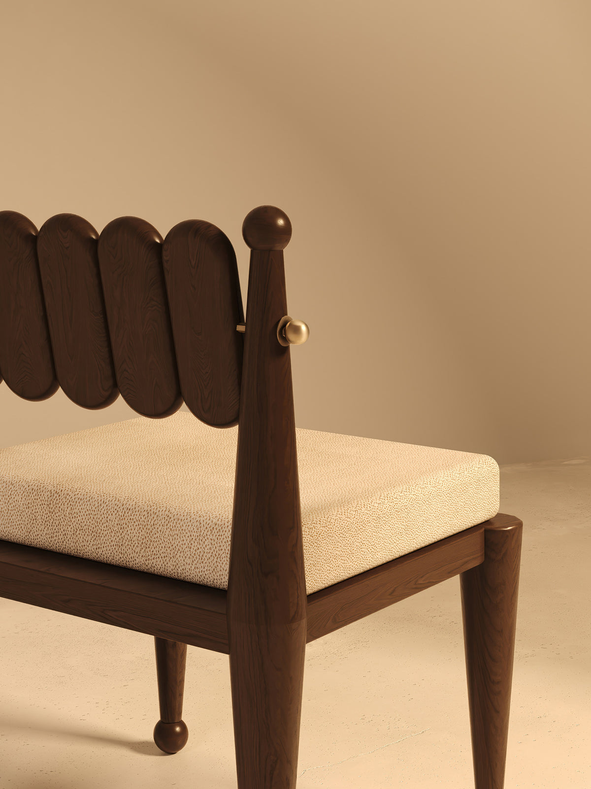 Close-up detail of walnut chair back with scalloped design and brass hardware