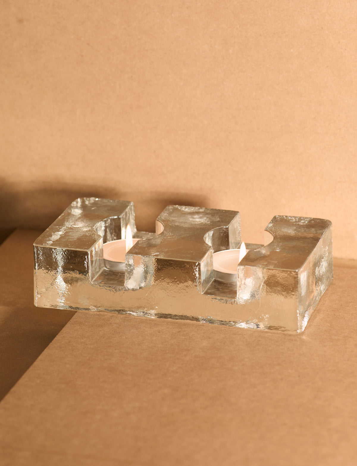 Important Scandinavian Clear Glass Candle Holder c. 1960 — side angle on brown backdrop