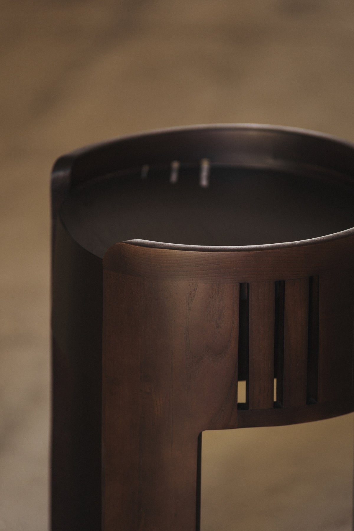 Curved walnut nightstand detail showing vertical slat design