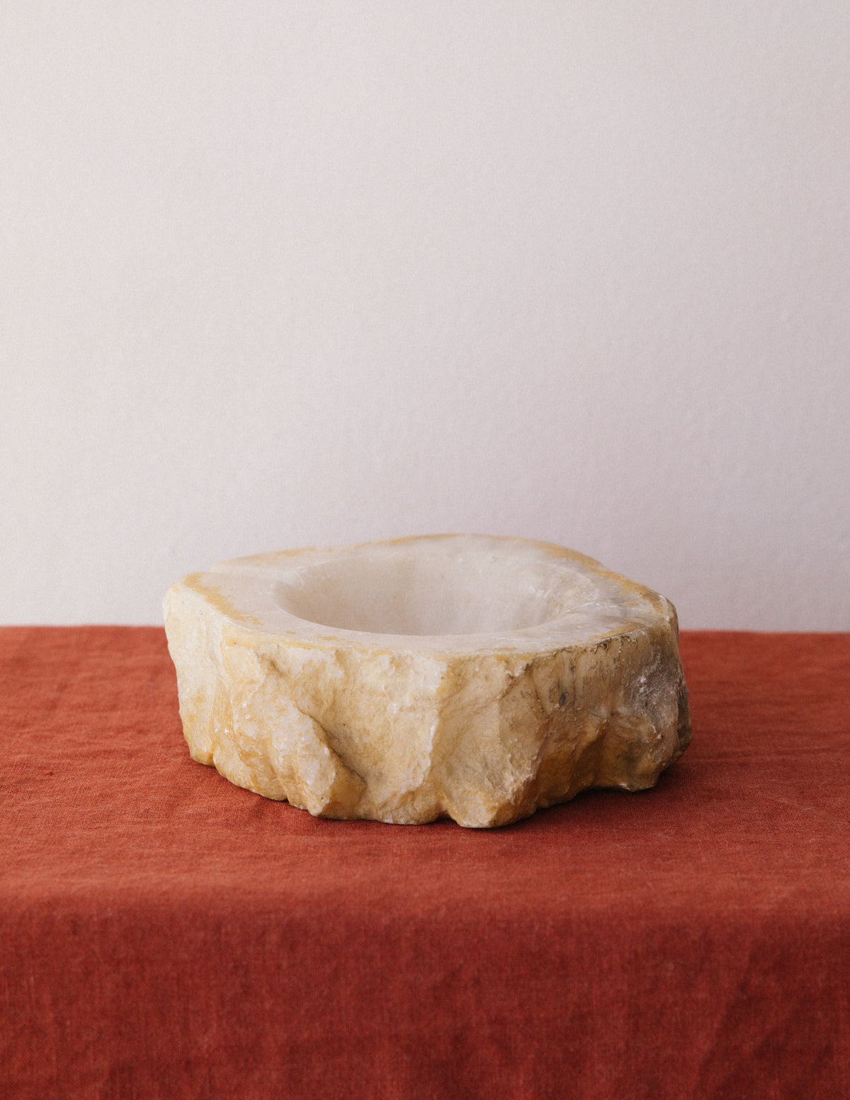 Round alabaster ashtray with natural stone texture and carved bowl