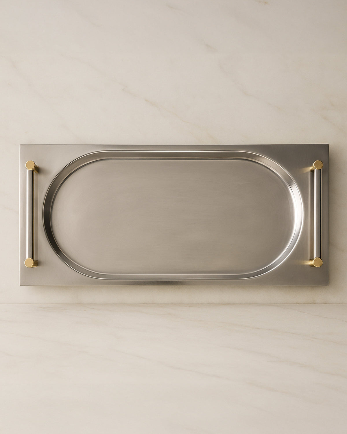 Overhead view of extra long silver serving tray with brass handles